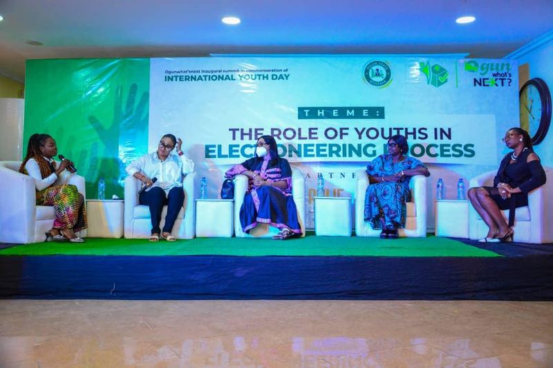 Panellists seated on stage in front of a backdrop reading “The Role of Youths in Electioneering Process”.